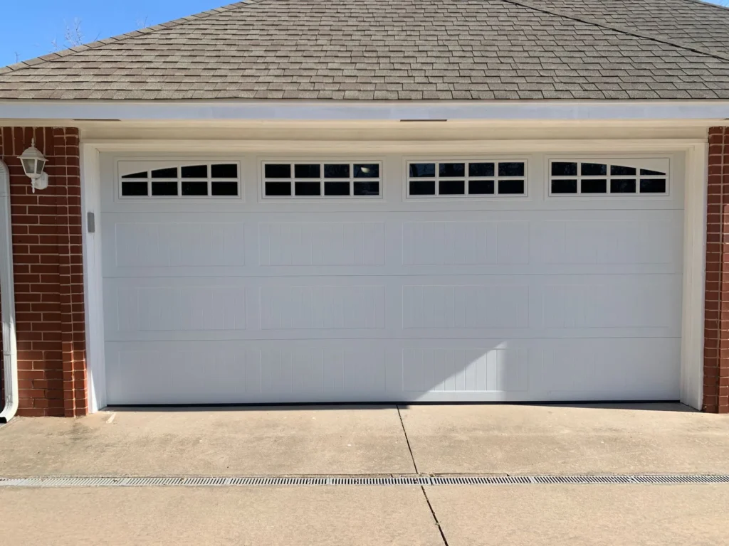 white traditional garage door after receiving garage door maintenance