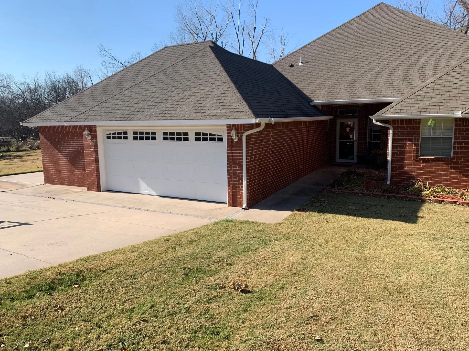 white traditional garage door on brick home